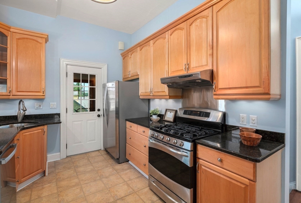 409 Atlantic Avenue Marblehead, MA 01945 - Photo 8 of 29 a kitchen with granite countertop a stove a sink dishwasher and a refrigerator