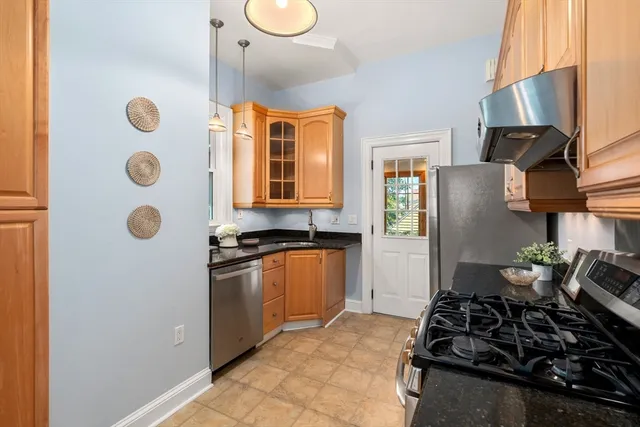 a kitchen with stainless steel appliances granite countertop a stove and a refrigerator