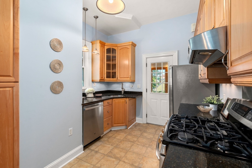 409 Atlantic Avenue Marblehead, MA 01945 - Photo 10 of 29 a kitchen with stainless steel appliances granite countertop a stove and a refrigerator