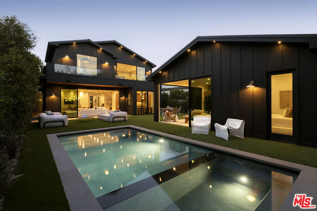 a swimming pool view with a outdoor seating space