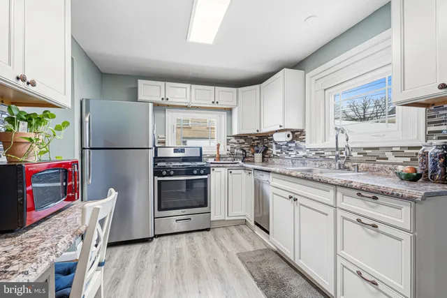 a kitchen with a refrigerator stove and sink