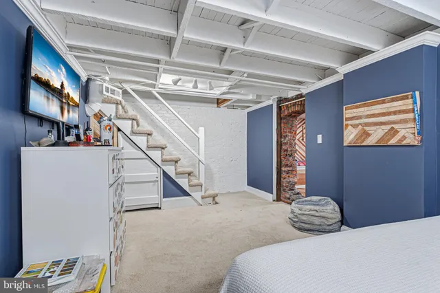 a bedroom with bed and a large window