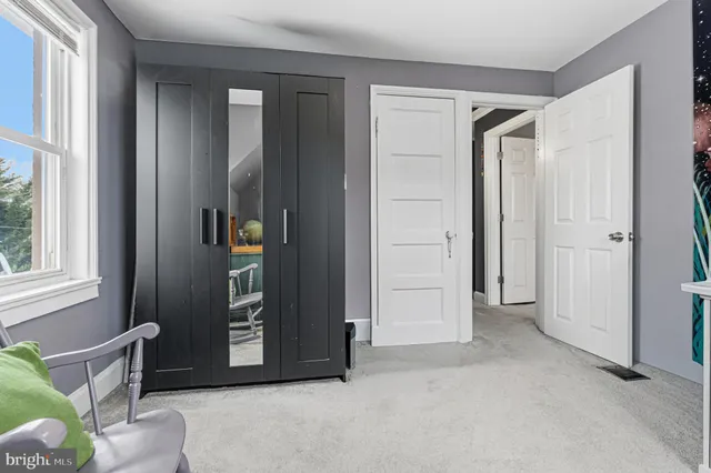 a bed room with a bed and a chair