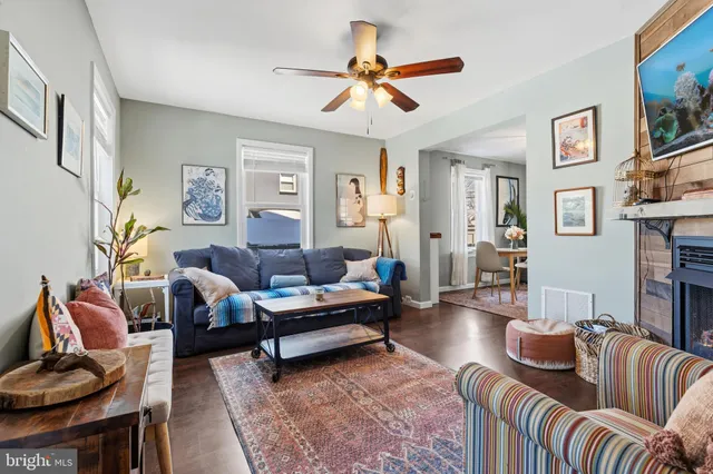 a living room with furniture ceiling fan and a rug