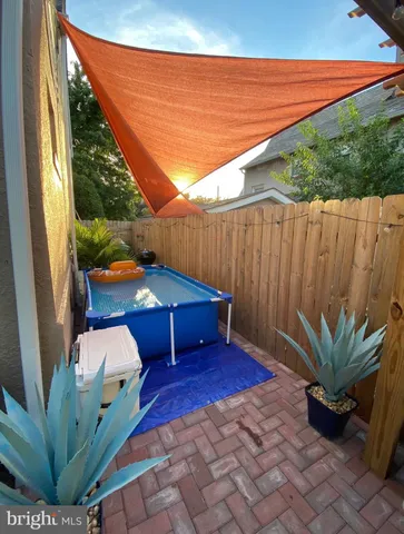 a view of a patio with couches and potted plants
