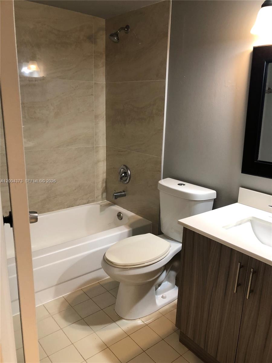 8761 Wiles Road, Unit 306 Coral Springs, FL 33067 - Photo 5 of 26 a bathroom with a toilet a sink and bathtub