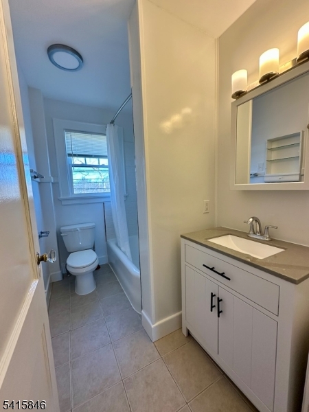 283 Main Street Chatham, NJ 07928 - Photo 12 of 15 a bathroom with a granite countertop toilet sink and mirror