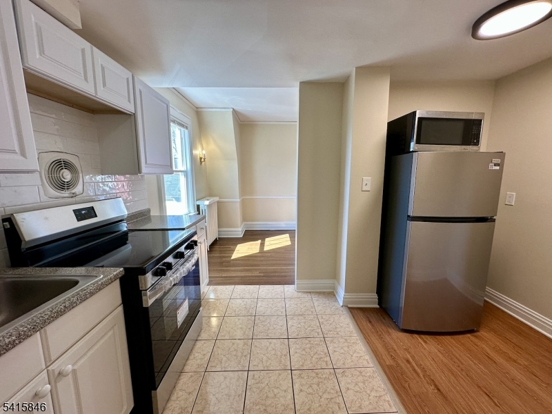 283 Main Street Chatham, NJ 07928 - Photo 5 of 15 a kitchen with granite countertop a refrigerator and a stove