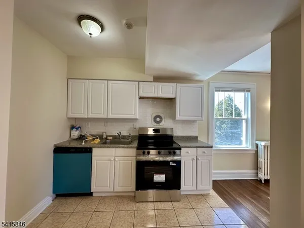 a kitchen with a stove a sink and a microwave