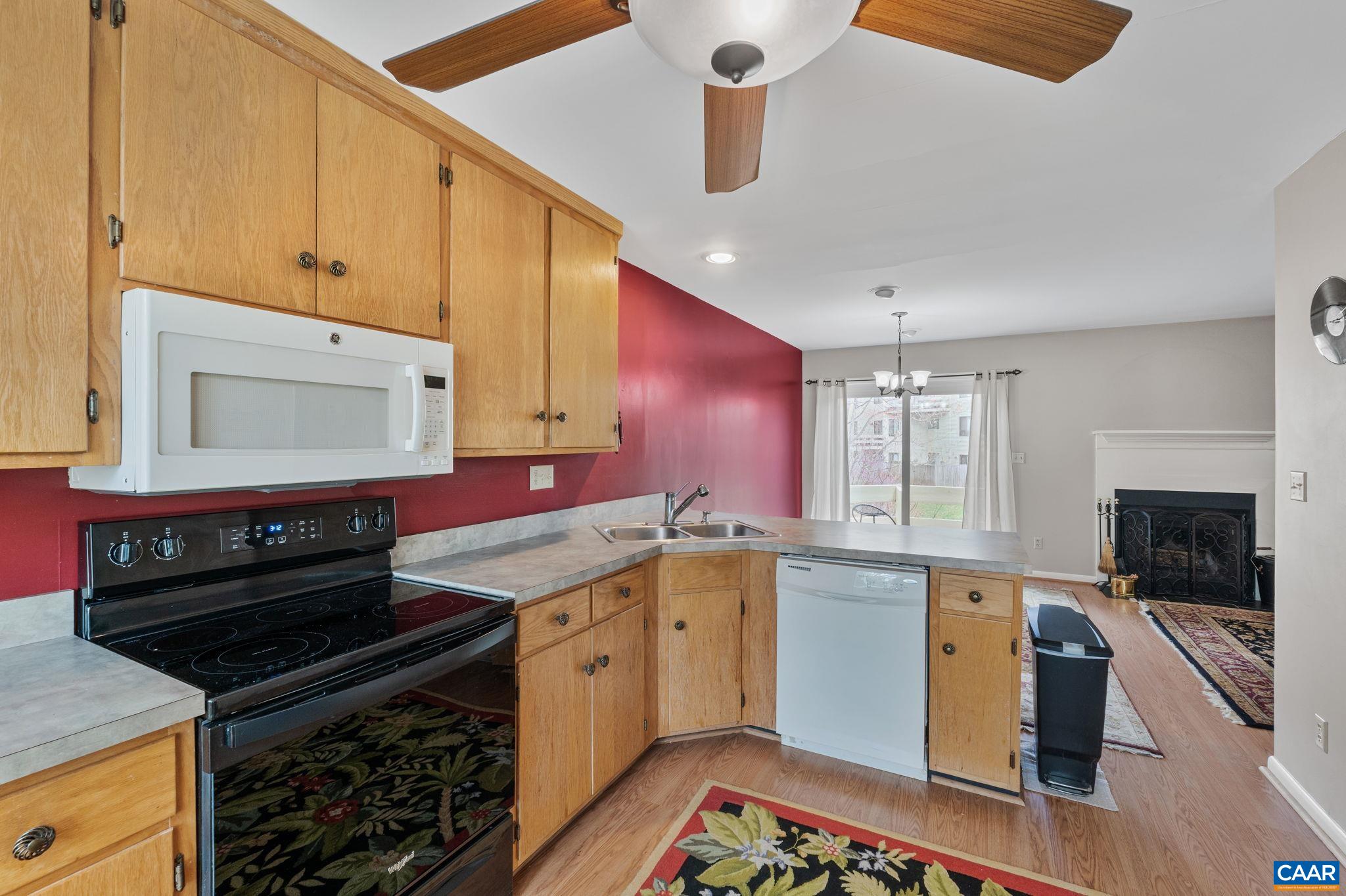 1212 Chatham Ridge Charlottesville, VA 22901 - Photo 6 of 17 a kitchen with granite countertop a stove sink and cabinets