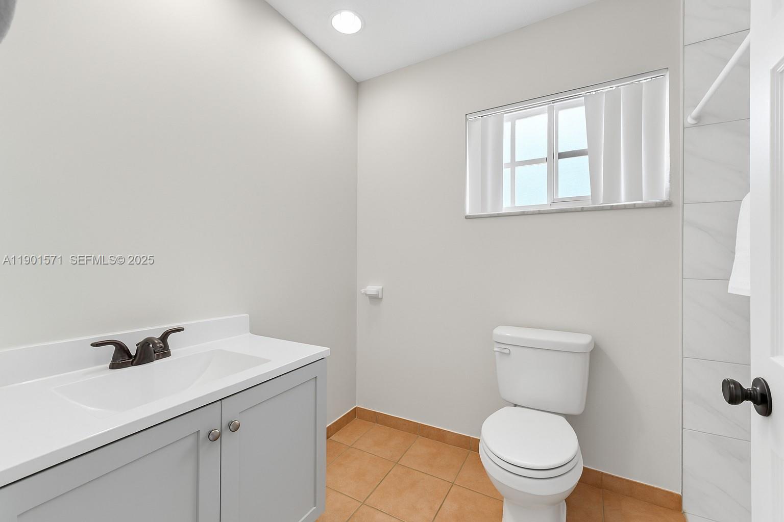 222 Northwest 14th Street Homestead, FL 33030 - Photo 14 of 26 a bathroom with a toilet a sink and mirror