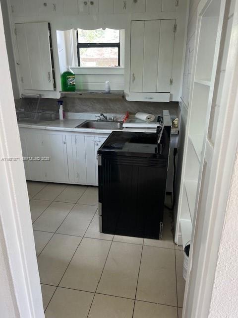 222 Northwest 14th Street Homestead, FL 33030 - Photo 23 of 26 a kitchen with a sink a stove and cabinets