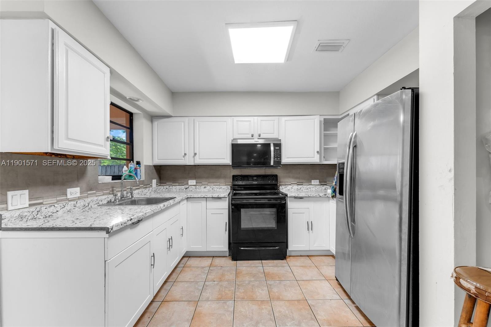 222 Northwest 14th Street Homestead, FL 33030 - Photo 7 of 26 a kitchen with stainless steel appliances granite countertop a refrigerator sink and stove