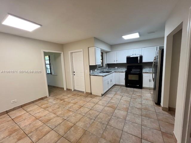 222 Northwest 14th Street Homestead, FL 33030 - Photo 8 of 26 a kitchen with granite countertop a refrigerator and a stove top oven
