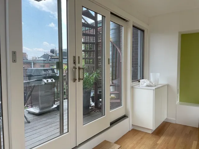 a bathroom with a glass door shower and a sink