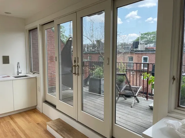 a view of a living room and a balcony