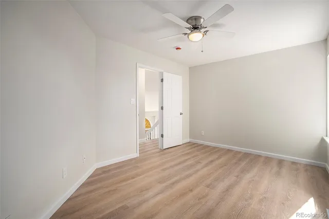 a bathroom with double vanity a toilet a and mirror