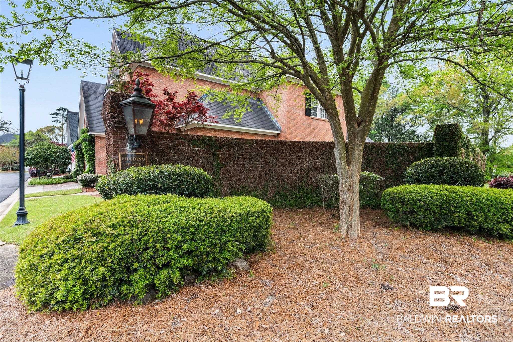 104 Fielding Place Mobile, AL 36608 - Photo 12 of 13 View of side of property with brick siding and a shingled roof