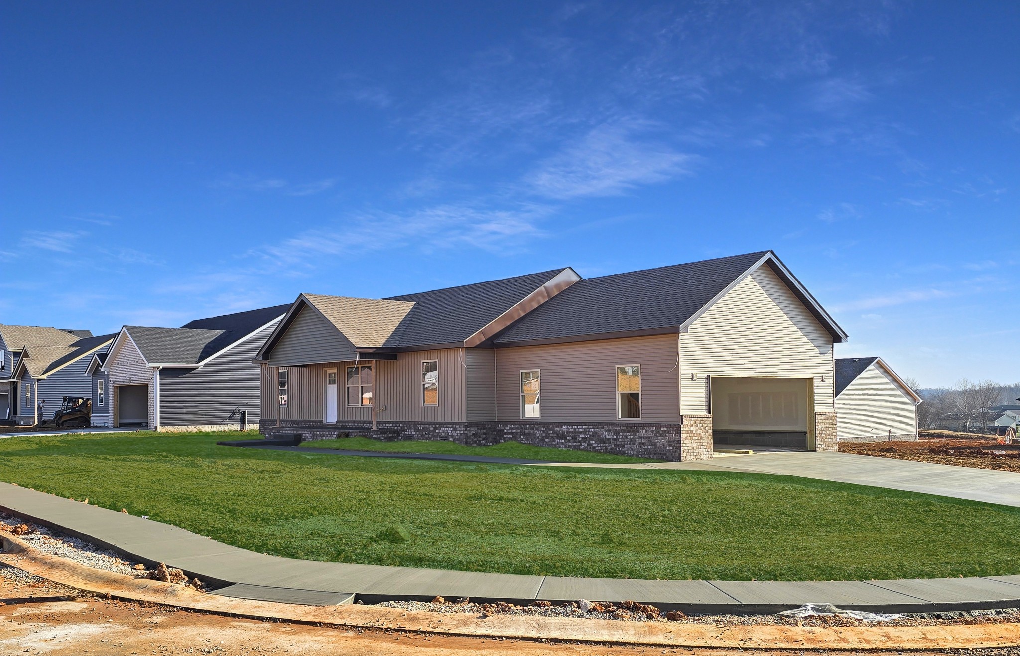 a front view of a house with a garden and yard