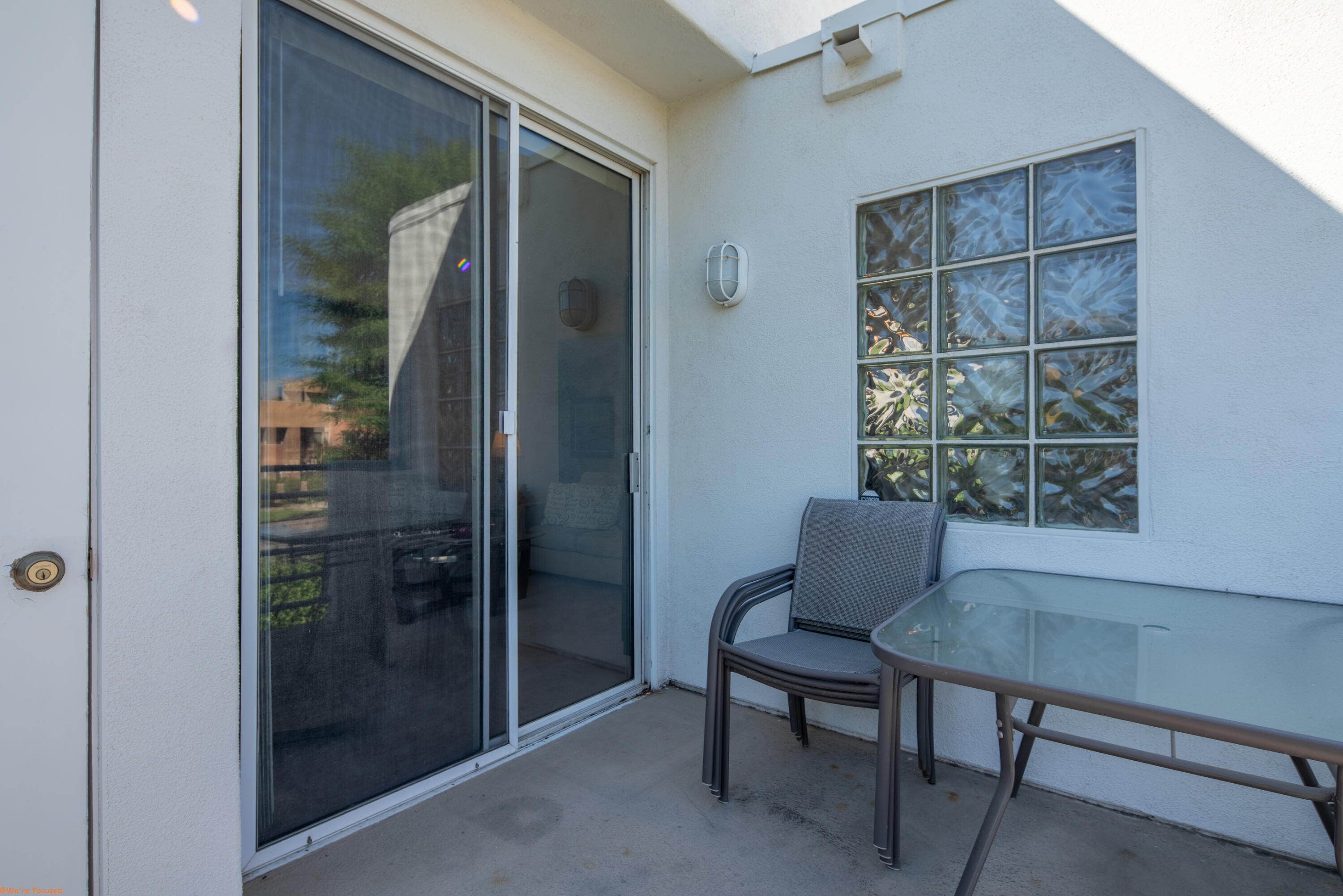 401 El Cielo Road, Unit 236 Palm Springs, CA 92262 - Photo 11 of 29 a room that has a glass door and a chair