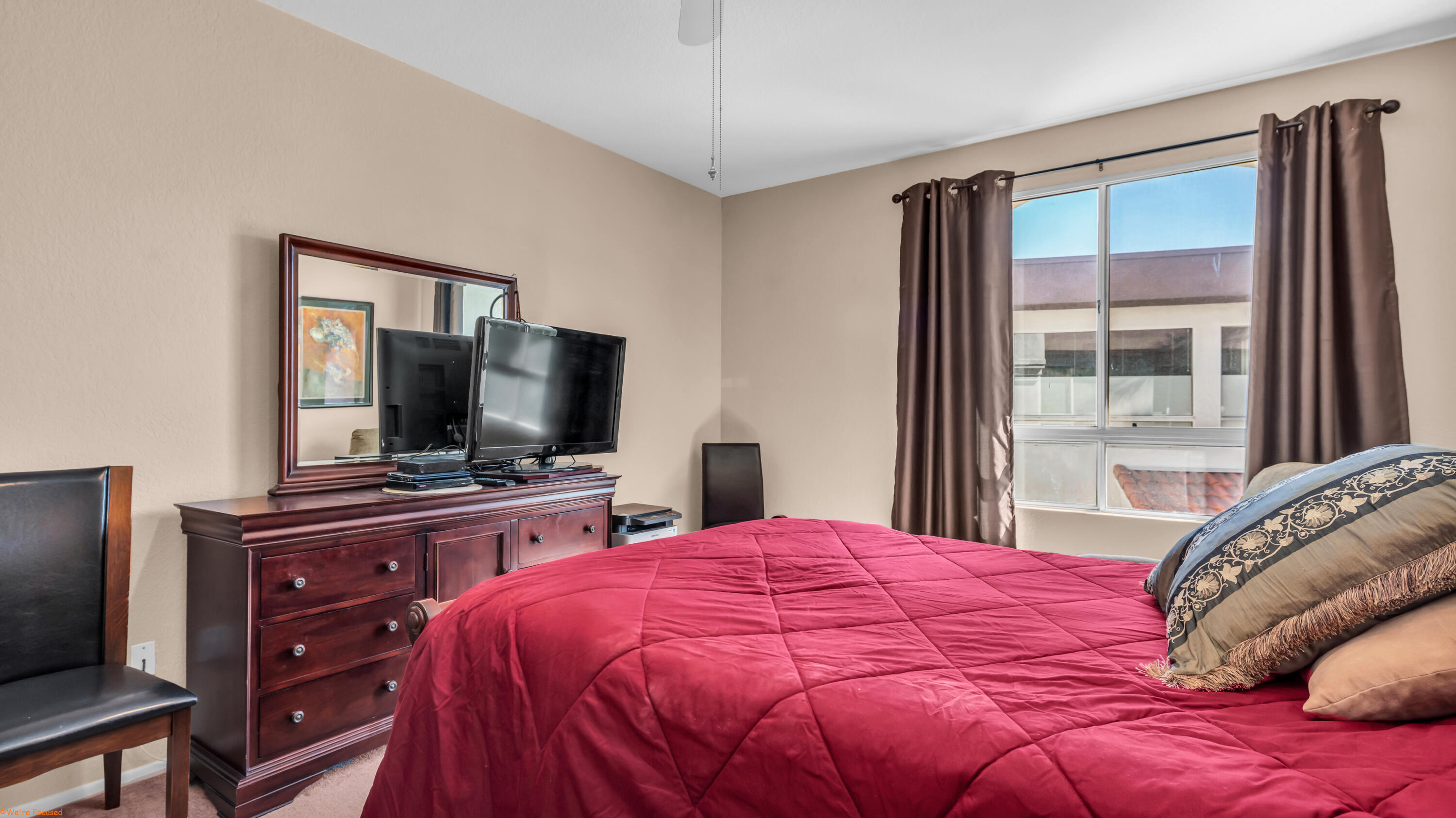 401 El Cielo Road, Unit 236 Palm Springs, CA 92262 - Photo 17 of 29 a bedroom with a bed and a flat screen tv