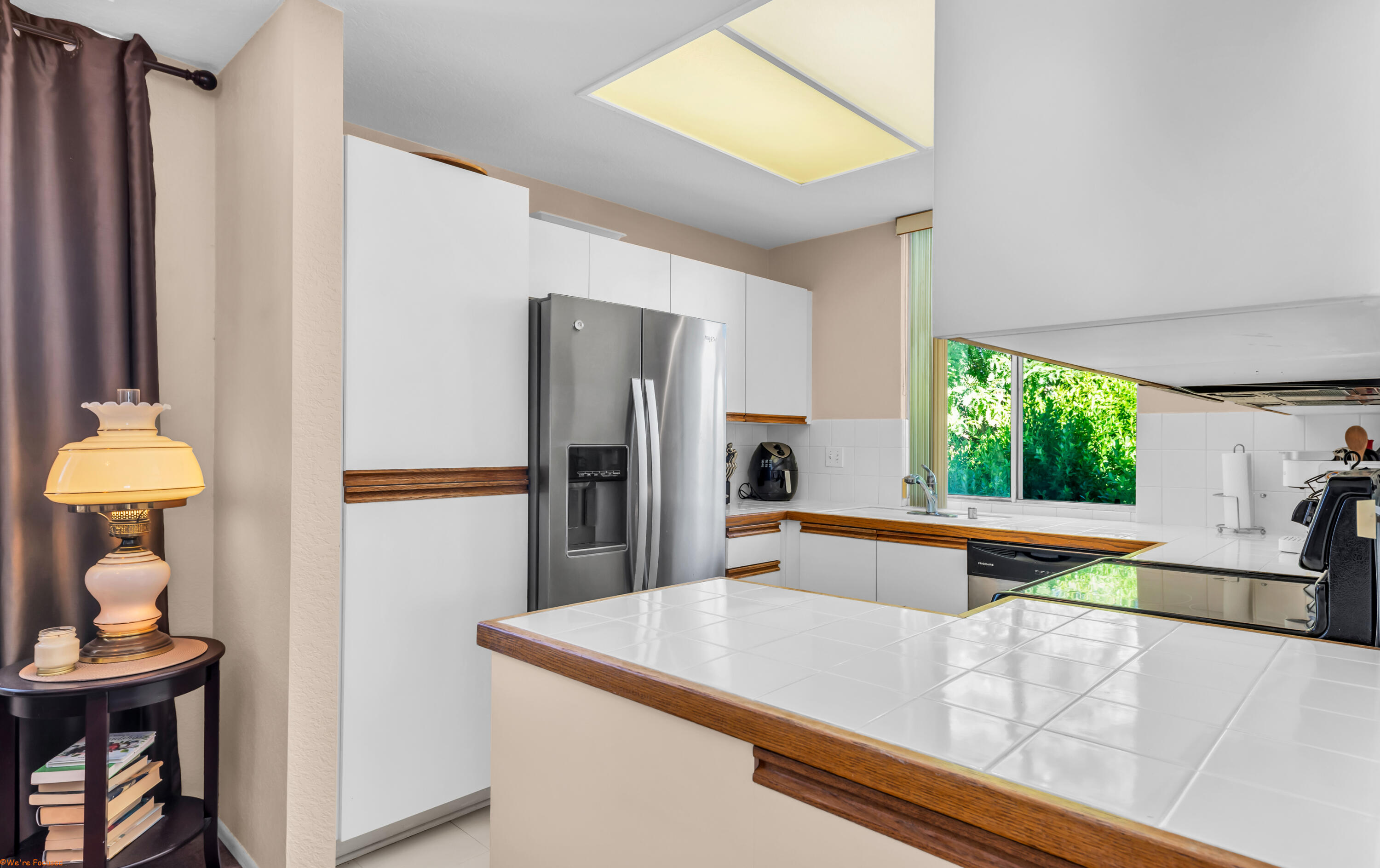 401 El Cielo Road, Unit 236 Palm Springs, CA 92262 - Photo 6 of 29 a kitchen with stainless steel appliances granite countertop a refrigerator and a sink