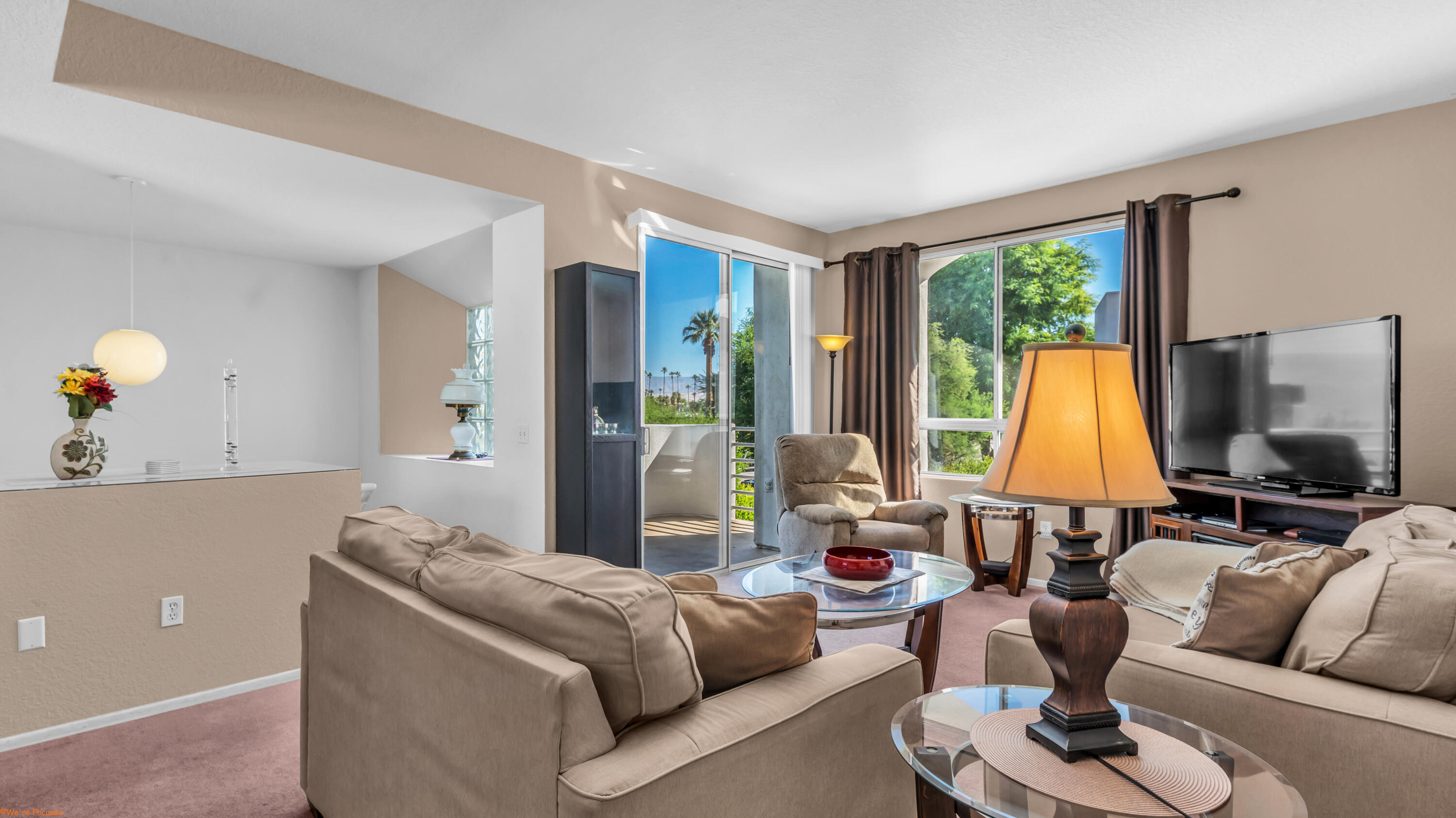 401 El Cielo Road, Unit 236 Palm Springs, CA 92262 - Photo 9 of 29 a living room with furniture and a flat screen tv