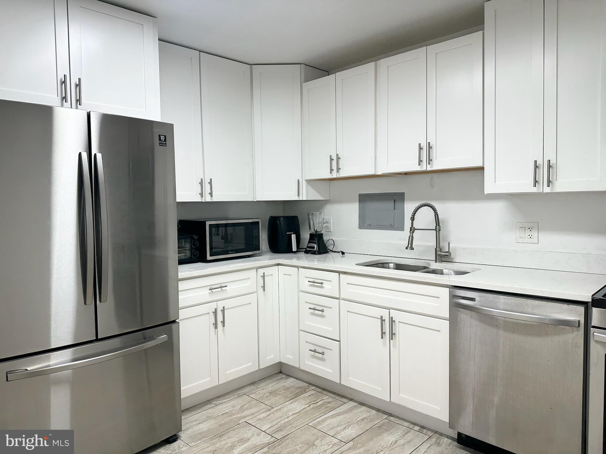 1836 Metzerott Road, Unit 901 Hyattsville, MD 20783 - Photo 5 of 25 Modern kitchen with sleek white cabinetry.