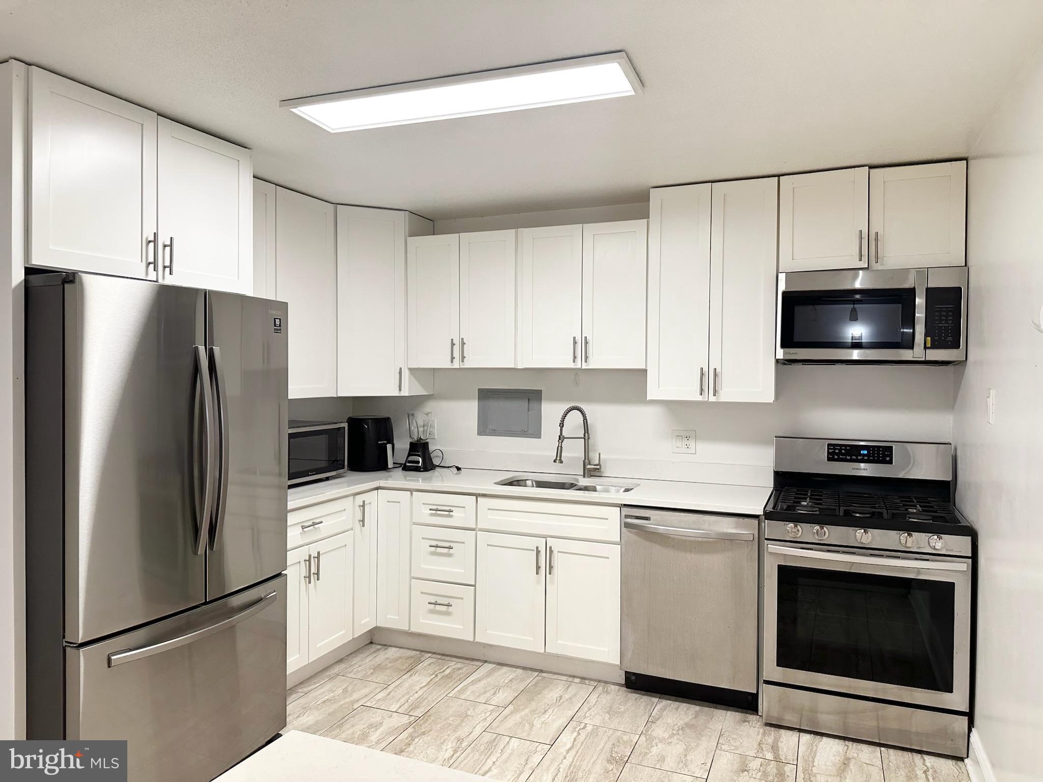 1836 Metzerott Road, Unit 901 Hyattsville, MD 20783 - Photo 6 of 25 Sleek modern kitchen with stainless appliances.