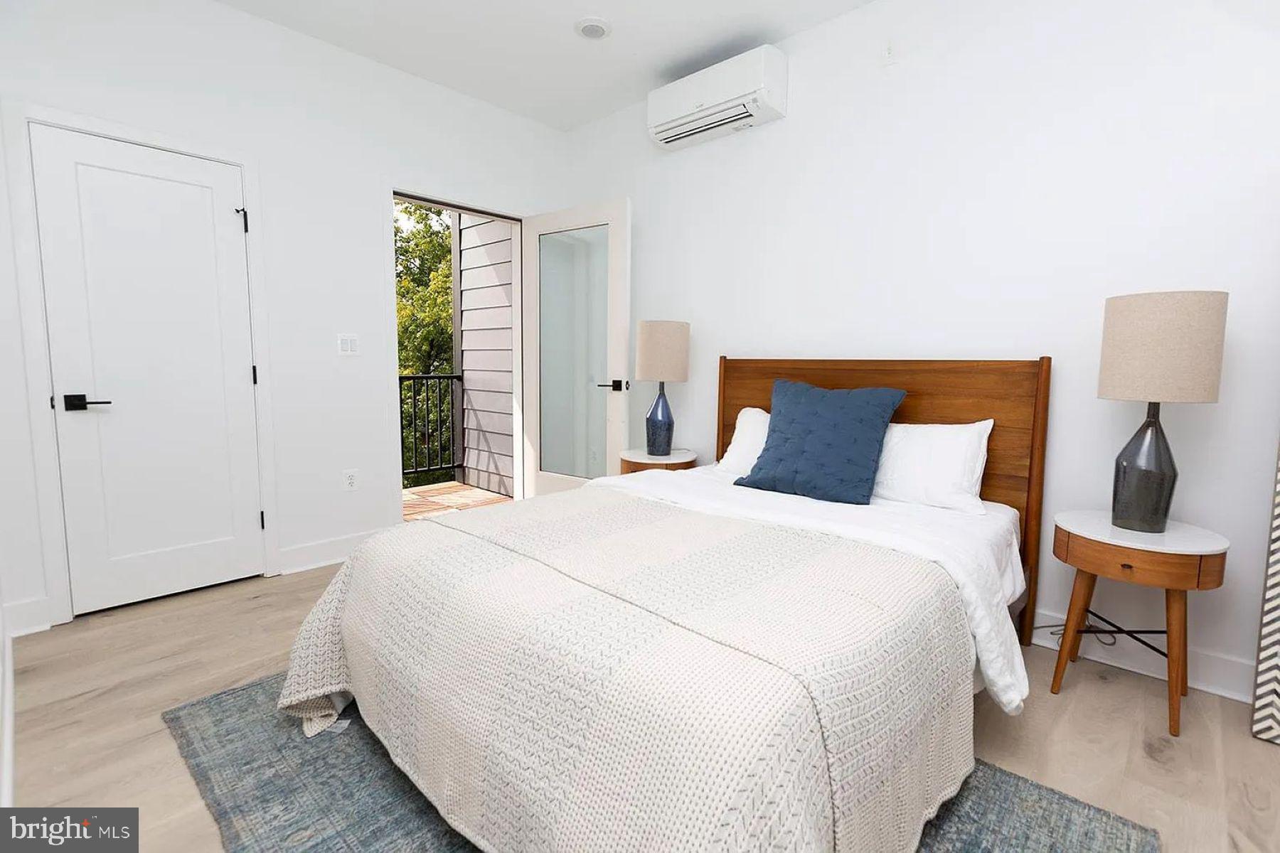 1617 Eastern Avenue, Unit 201 Baltimore, MD 21231 - Photo 6 of 13 a bedroom with a bed and a potted plant