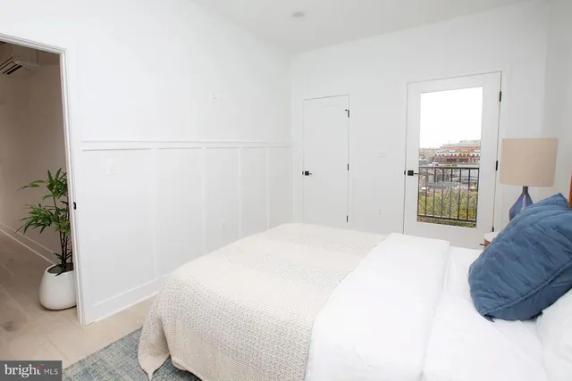 a bedroom with a bed and a potted plant