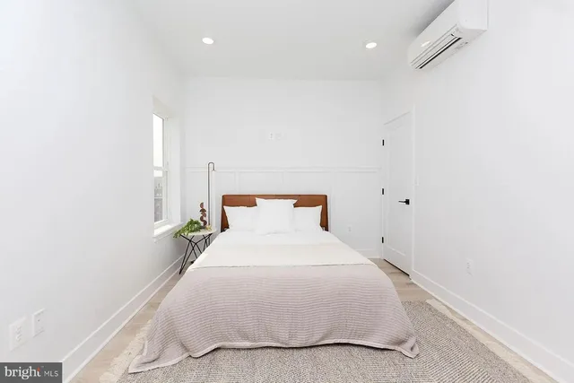 a bedroom with a bed and a night stand