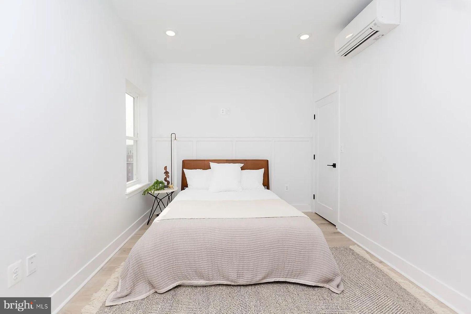 1617 Eastern Avenue, Unit 201 Baltimore, MD 21231 - Photo 8 of 13 a bedroom with a bed and a night stand