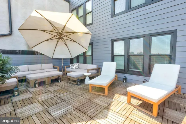 a couple of table and chairs under an umbrella