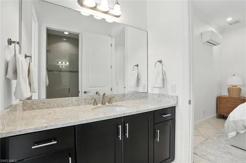 a bathroom with a sink double vanity and a mirror