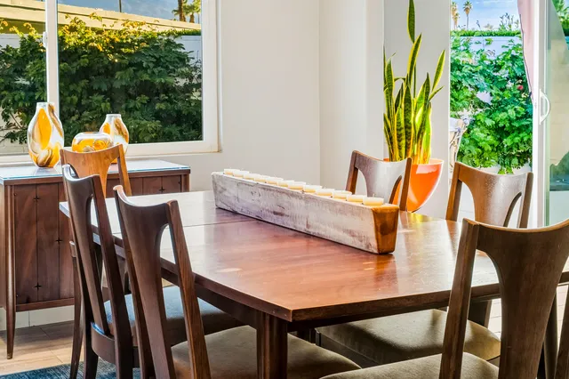 a view of a dining room with furniture window and garden view