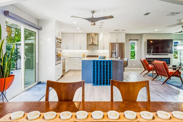 a living room with furniture a rug and a chandelier
