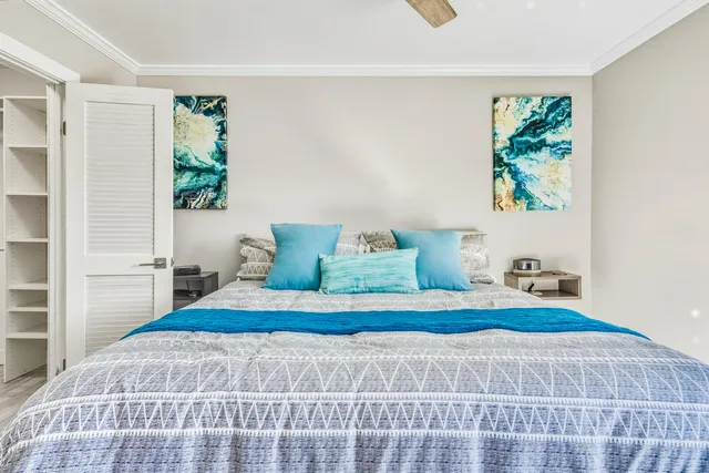 a bedroom with a bed and wooden floor