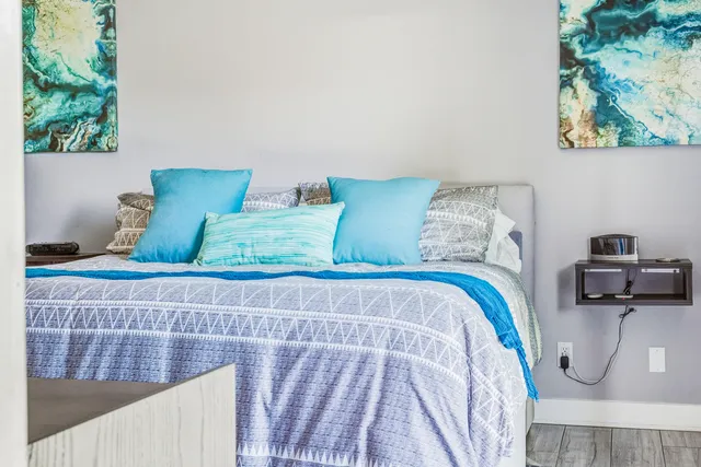 a bedroom with a bed and a chair