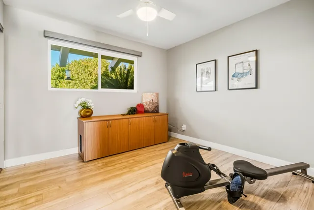 a bedroom with furniture and a flat screen tv