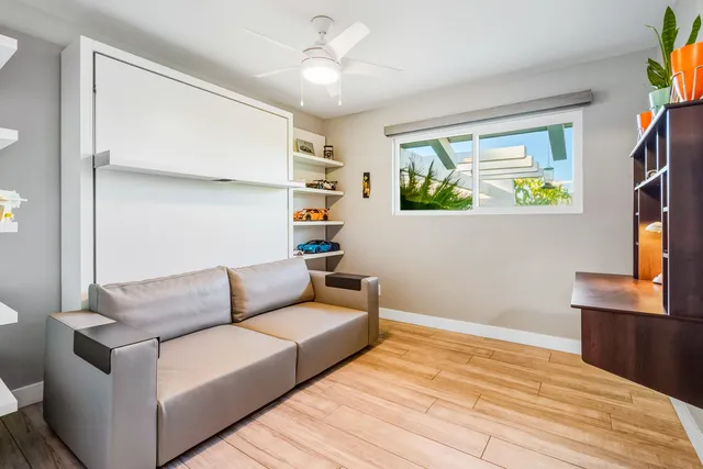 a bathroom with a granite countertop sink mirror vanity and toilet