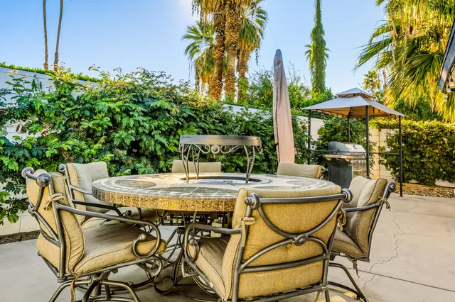 an aerial view of a house with a yard and potted plants