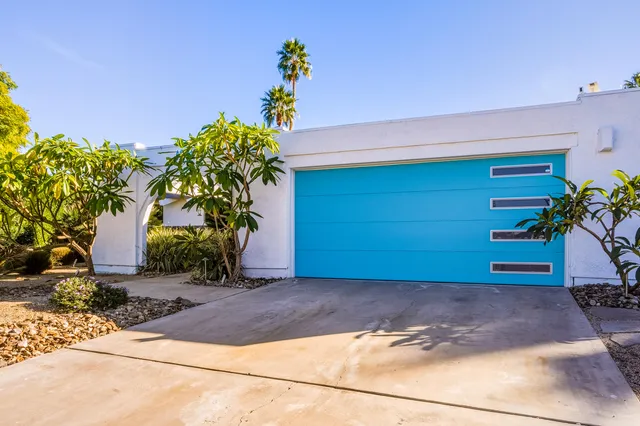 a view of a house with backyard sitting area and garden