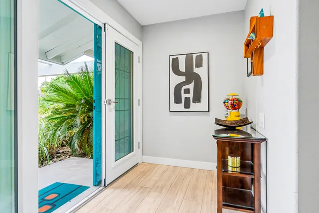 a room that has a bed and a potted plant on the wall