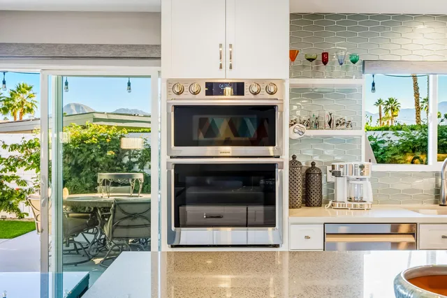 a living room with a fireplace and a floor to ceiling window