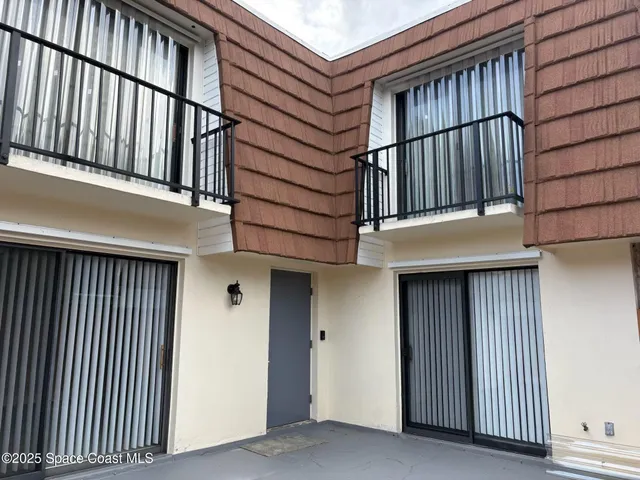 a view of a kitchen with wooden floor and a refrigerator