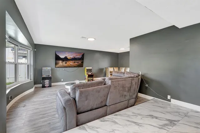 a dining room with furniture and a floor to ceiling window