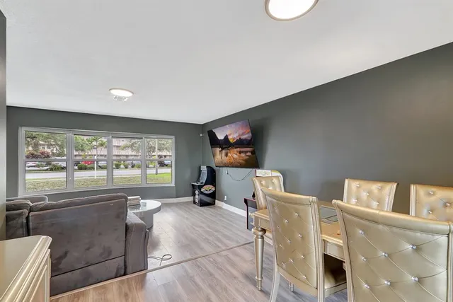 a view of a dining room with furniture and wooden floor