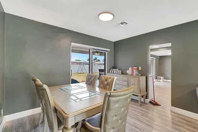 a large kitchen with stainless steel appliances granite countertop a refrigerator and a stove top oven