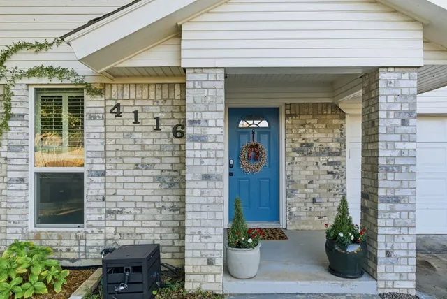 a front view of a house with potted plants